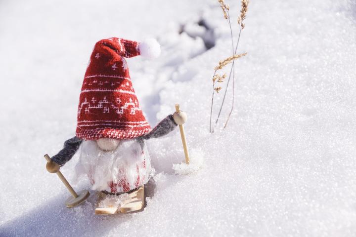 Skiing santa gnome in the snow