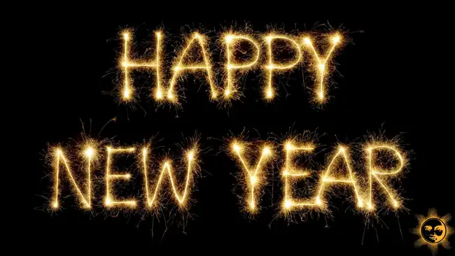 happy new year written in sparklers fireworks on a dark background